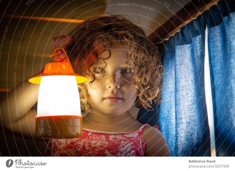Beautiful girl with torch Girl Small Flashlight Torch Child Playful Intellect Story horror story telling Playing Human being Cute Delightful Curly hair Earnest