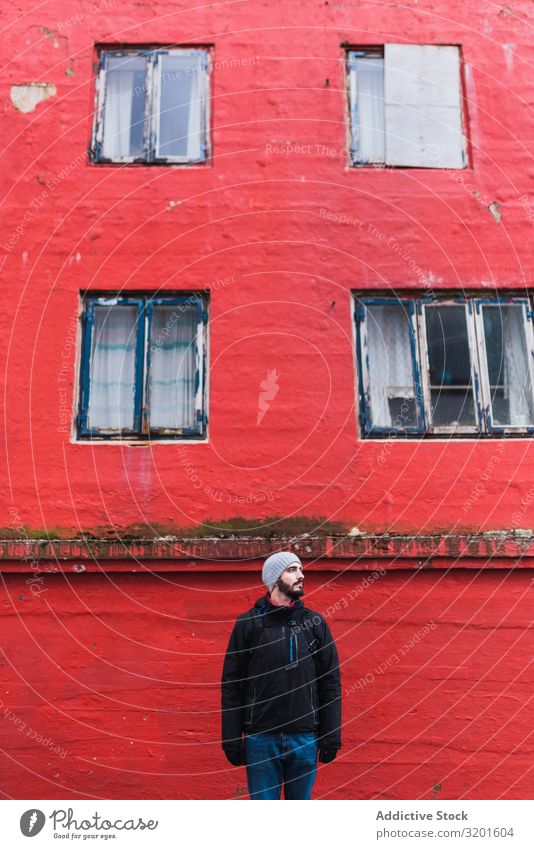 bearded man looking away while standing in front of red building in faroe island Model Attractive Man handsome Beautiful Calm Lifestyle suave