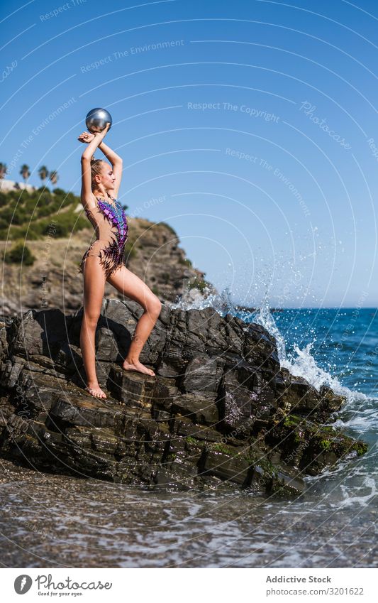 Female gymnast sitting on rocks and practicing Gymnast Woman rhythmic Athlete Ball Practice Gymnastics Sports Youth (Young adults) Human being Athletic Healthy