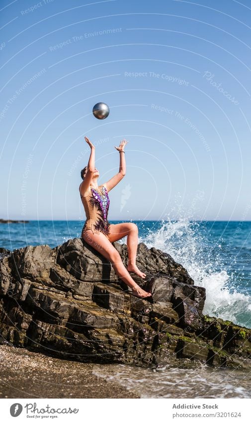 Female gymnast sitting on rocks and practicing Gymnast Woman rhythmic Athlete Ball Practice Gymnastics Sports Youth (Young adults) Human being Athletic Healthy