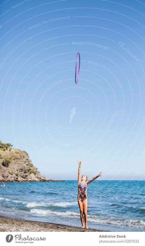 Graceful acrobat performs with hoop on beach Gymnast Woman rhythmic String Athlete Practice Gymnastics Sports Youth (Young adults) Human being Athletic artistic