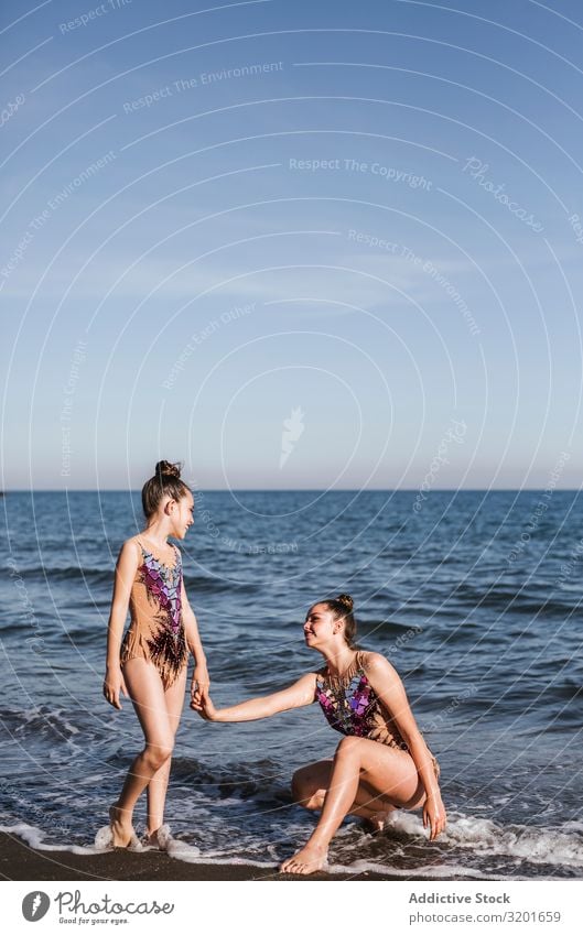 Female gymnasts holding hands on sea background Woman Gymnast rhythmic Athlete Sports pose Gymnastics Youth (Young adults) Girl Human being Athletic Thin