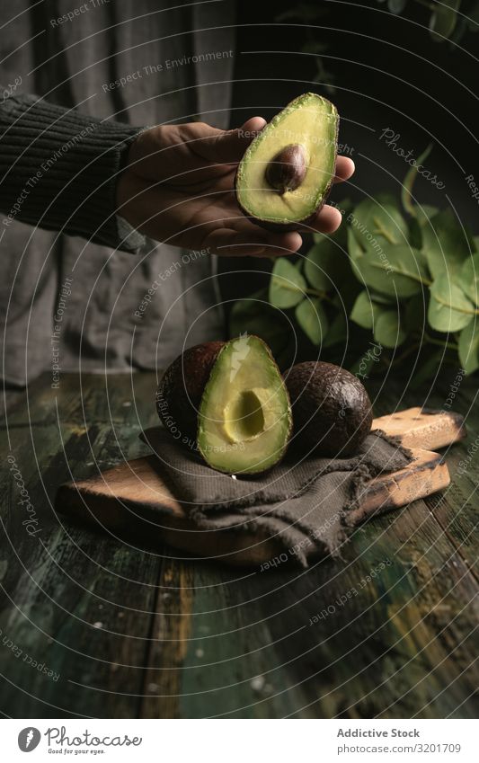 Person hands holding avocados Avocado Cut Diet Exotic Food Fresh Fruit Green Half Healthy Natural Nature Nutrition Organic Raw Mature Seed Tropical Vegan diet