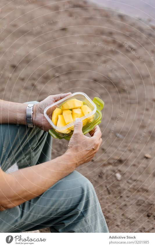 Man hands eating mango Fruit Eating Nature Forest Summer Healthy Natural Exterior shot Mango Tupperware Lifestyle Sit Adults Food Human being