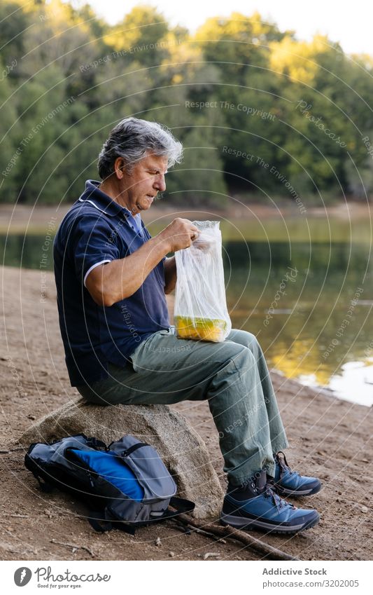Man preparing to eat fruit Fruit Eating Nature Forest Summer Healthy Natural Exterior shot Mango Tupperware Bag Lifestyle Sit Adults Food Human being Delicious