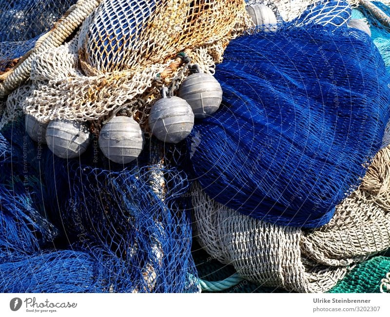 Blue and beige fishing nets with buoyancy aids in Sardinia Network Fishery Harbour meshes Fishing (Angle) Fishing port wharf Dry storage balls Knot Beige