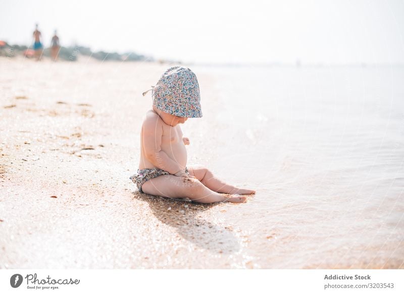 Cute baby sitting on beach Baby Beach Delightful Sand Wave Summer Coast Leisure and hobbies Joy Child Vacation & Travel Strange Sun Ocean Toddler Tropical Small