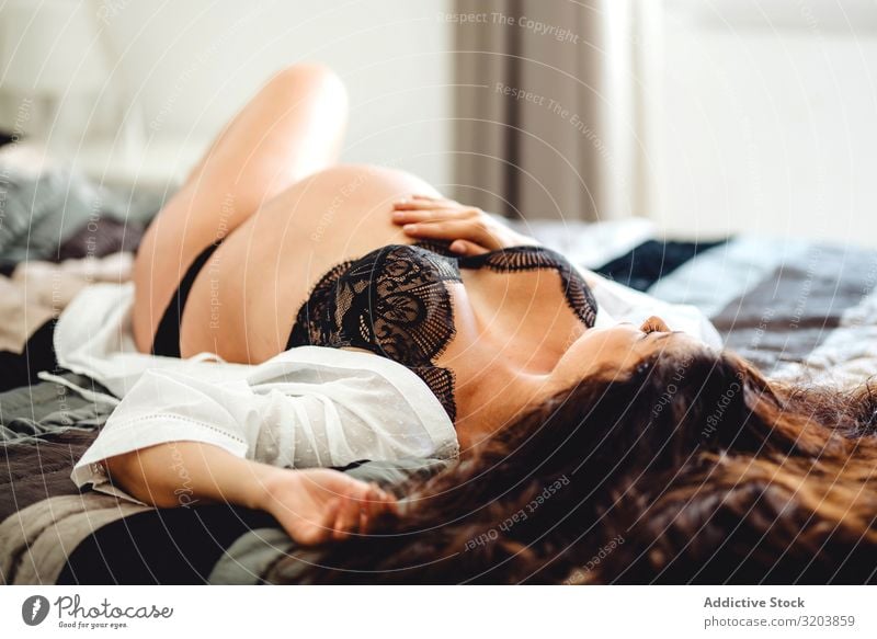 Pregnant female in underwear lying on bed Woman Underwear Showing one's bellybutton expecting Baby fetus Youth (Young adults) Human being Beautiful Attractive