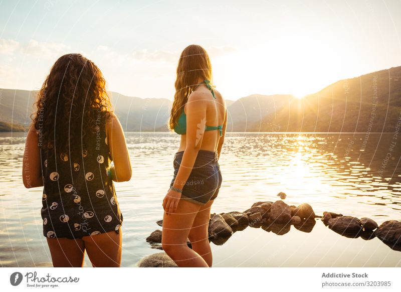 Women on coast in sunset light Woman Coast Sunset girlfriend Swimsuit Summer Vacation & Travel Beach Together Youth (Young adults) Nature Water Relaxation Peace
