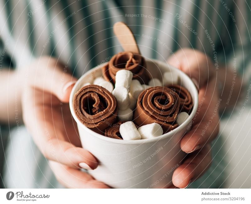 Hand holding rolled ice cream in cone cup Roll Rolled Ice cream Woman Cream Chocolate ice-cream Baking Fruit Frying copy Universe Copy Space Background picture