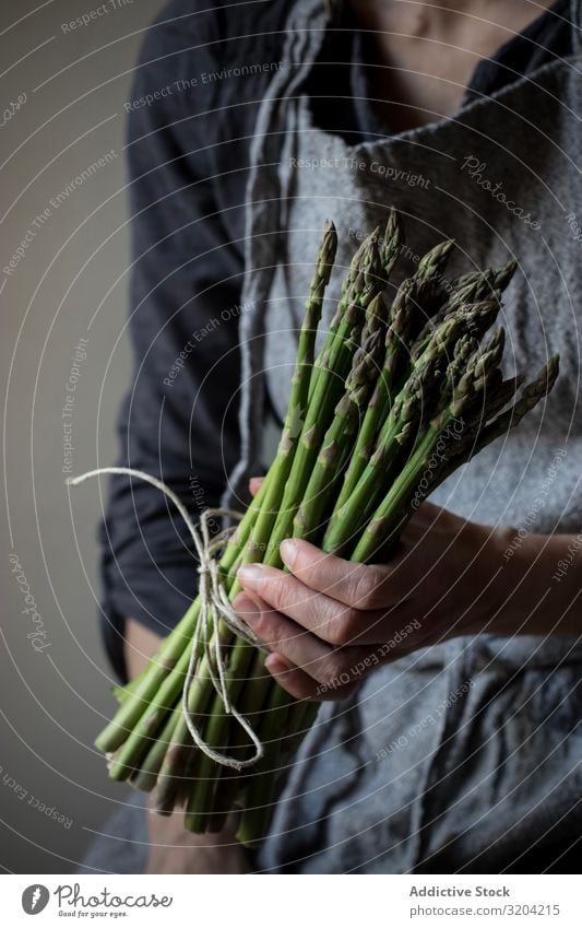 Faceless woman holding bundle of green asparagus Woman Asparagus Rustic Green Bundle Hand Hold Organic Diet Food Natural Nutrition Raw Ingredients