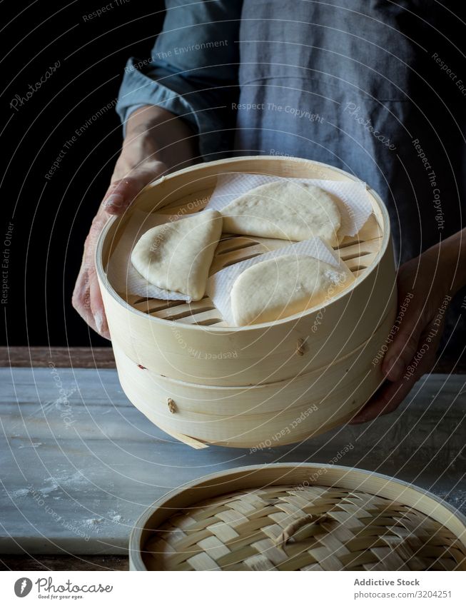 Cook preparing buns in bamboo steamer Bamboo Steamer Roll Cooking Tradition Lotus Bread gua bao Food Snack Dish Basket Delicious Dough oriental Meal Gourmet