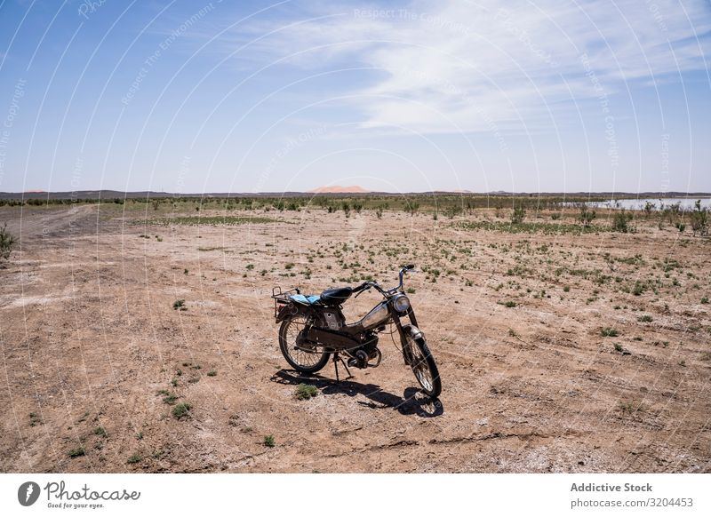 Motorcycle in spacious desert terrain Desert Tourism Morocco Sand Bicycle Lanes & trails Track Landscape Remote Loneliness Ground Sunlight Heat Sky Energy