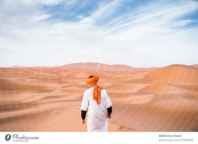 Man in turban walking among sand dunes Dune Desert Turban Morocco Walking Sand Nature Vacation & Travel Dry Landscape Hot Tourism Adventure Freedom Loneliness