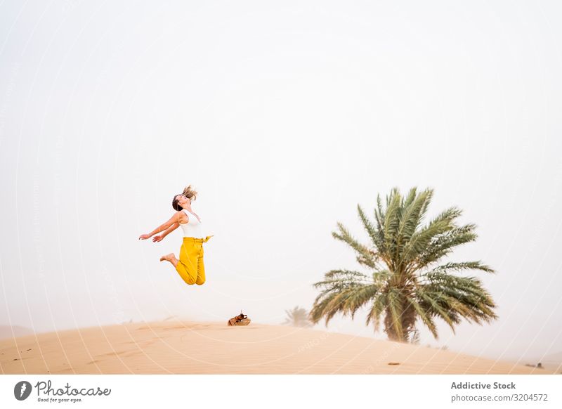 Happy woman jumping in desert Woman Desert Cheerful Vacation & Travel Style Guest Morocco Hip & trendy Joy Summer Beauty Photography Remote Blonde Contentment
