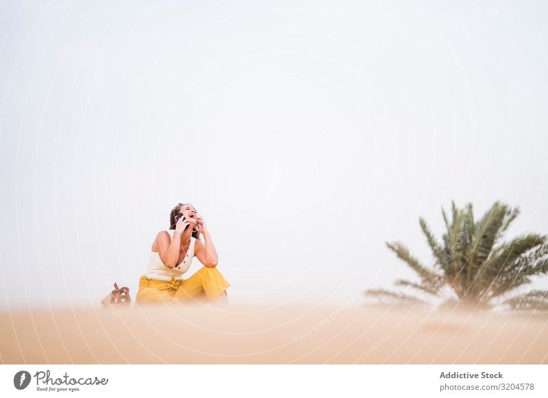 Happy woman using smartphone in desert Woman Desert Cheerful Communication Cellphone Technology Vacation & Travel Style Guest Morocco Joy Summer