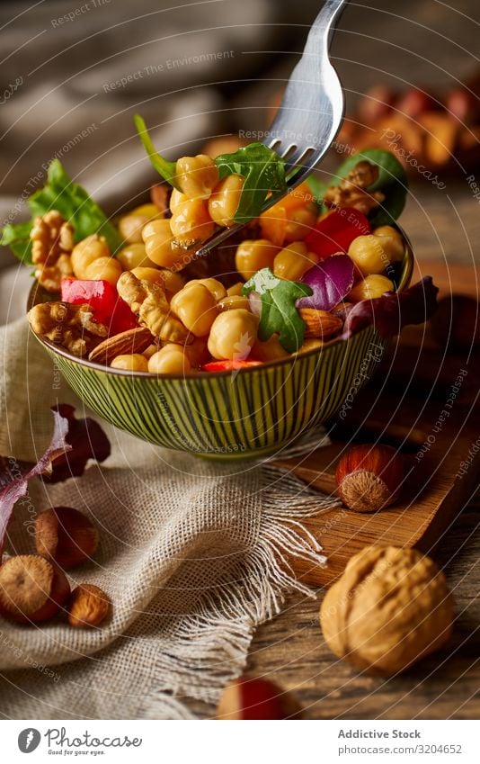 Bright vegetables with chickpeas in bowl and walnuts Chickpeas Walnut Nut Vegetable Healthy Food Organic Vegan diet appetizing Green Salad Raw Eating Meal Fresh