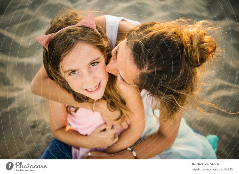 Woman with daughter on sunny beach Daughter Beach Love Embrace Family & Relations Summer Mother Together Girl Sand Parents Vacation & Travel Bonding Contentment