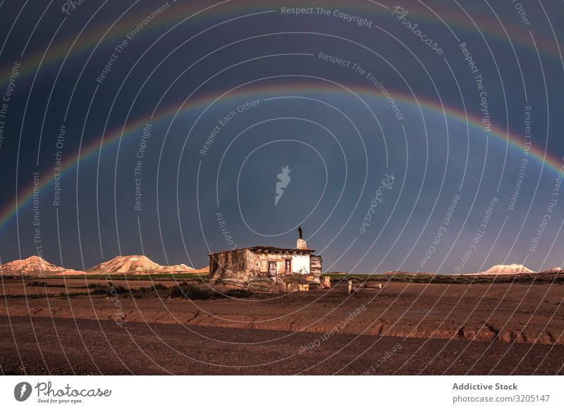 Lonely house in desert and rainbow in sky Desert Rainbow Hill Landscape Sand Stone Plant Multicoloured Dry Nature Sky Vacation & Travel Hot Colour Dune Tourism