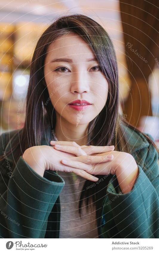 Portrait of young asian woman looking at camera Woman Café Table Sit Youth (Young adults) Looking into the camera approachable To enjoy Lifestyle