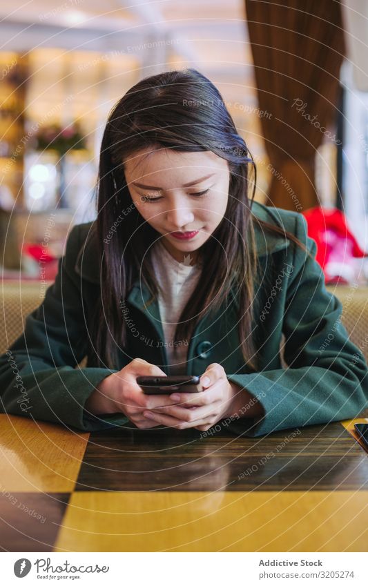 Asian woman using smartphone in cafe Woman PDA Café Sit Table asian Cozy Lifestyle Leisure and hobbies Ethnic Rest Relaxation Style Hip & trendy Elegant