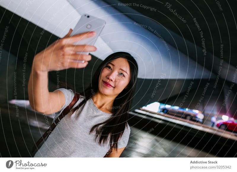 Asian female taking selfie in underground passage Woman Selfie Underground Passage Posture Smiling asian Youth (Young adults) PDA Easygoing Town grungy Parking