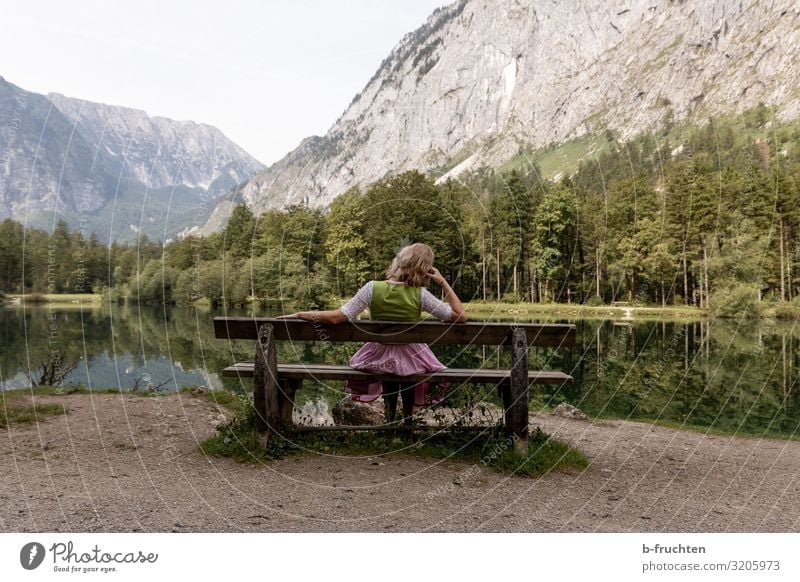 Woman on a wooden bench in front of a mountain lake Vacation & Travel Tourism Trip Summer Mountain Hiking Adults 1 Human being Nature Beautiful weather Park