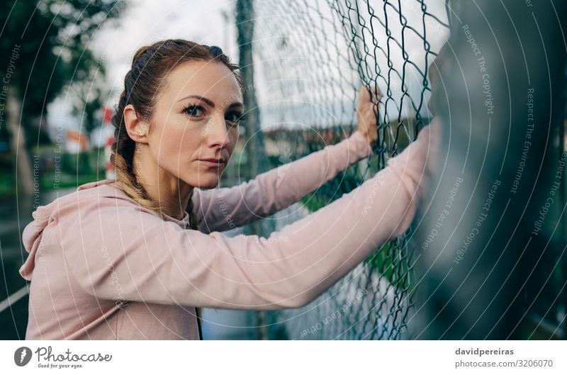Sporty girl resting on sports court fence Lifestyle Beautiful Body Leisure and hobbies Sports Human being Woman Adults Clouds Rain Fitness Authentic