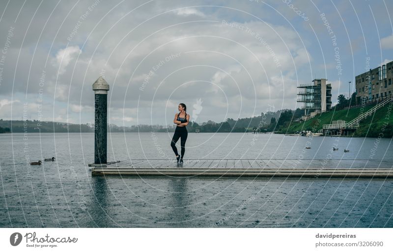 Sportswoman looking lake from pier Lifestyle Style Body Calm Human being Woman Adults Landscape Clouds Rain Coast Lake Building Sneakers Fitness Authentic Thin