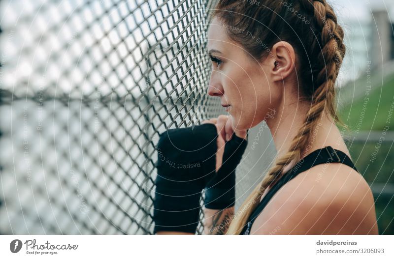 Sportswoman looking through a fence Lifestyle Beautiful Body Face Leisure and hobbies Human being Woman Adults Hand Clouds Gloves Fitness Authentic Strong Brave