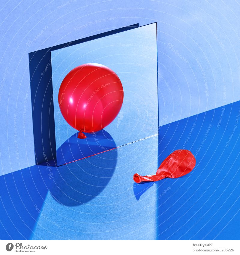 A balloon reflecting itself with a wrong reflection Table Mirror Fashion Balloon Glittering Blue Red Still Life Hard light wall square squareformat cold empty
