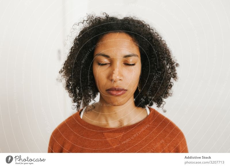 Portrait of young black woman with closed eyes meditation practicing relaxation beautiful female meditate wellness slim spirituality wellbeing attractive mind