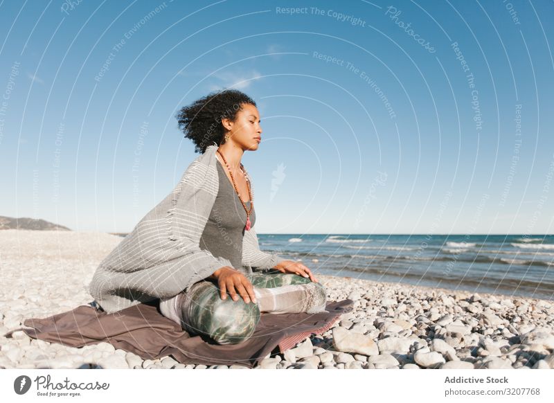 Sportive woman sitting on sandy beach in asana meditating practicing yoga position relaxation exercise beautiful fitness sport leisure female workout meditate