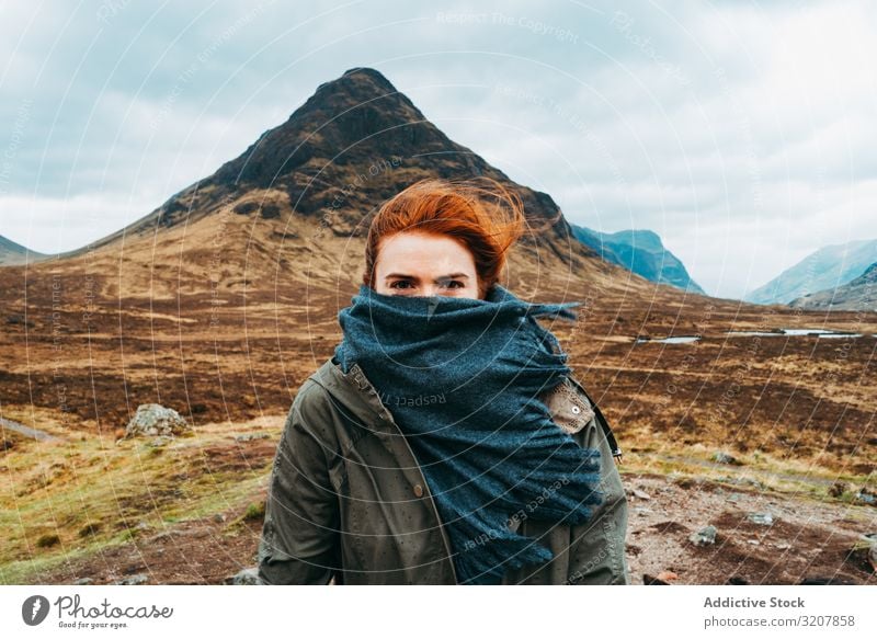 Redhead woman in scarf against mountains wind scotland ginger redhead nature cold landscape travel covered view valley beauty freedom adventure young beautiful