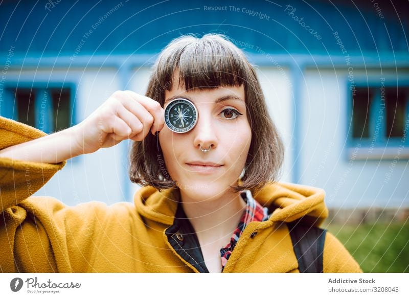 Funny woman with compass near eye crossed eyes funny grimace navigation retro smiling adventure tourism guidance house female vintage tool face expression