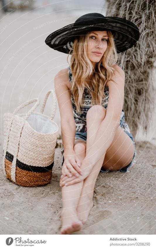 Young beautiful female relaxing on beach woman hat fashionable glamorous summer vacation travel recreation holiday resort young person attractive blonde pretty