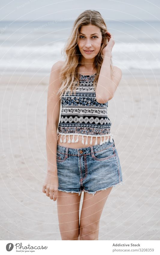 Happy female laughing on sandy beach woman happiness fashionable glamorous summer vacation travel recreation holiday resort young person attractive beautiful