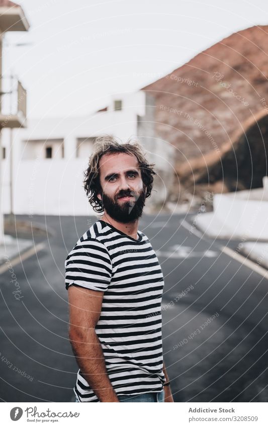 Bearded male on deserted road man striped t-shirt la restinga el hierro canary island vacation travel adventure journey tourism young person handsome cheerful