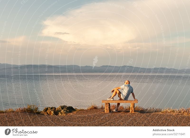 Man sitting on bench and enjoying sea view man seascape vacation serene amazing landscape ocean observe water summer beach calm male clear scenic holiday