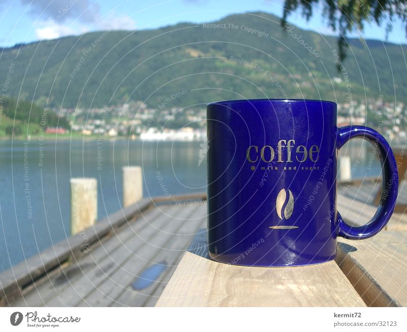 Norwegian Coffee Mug Cup Lake Norway Vacation & Travel Depth of field Gastronomy coffee Blue golden writing Mountain Sun depth blur