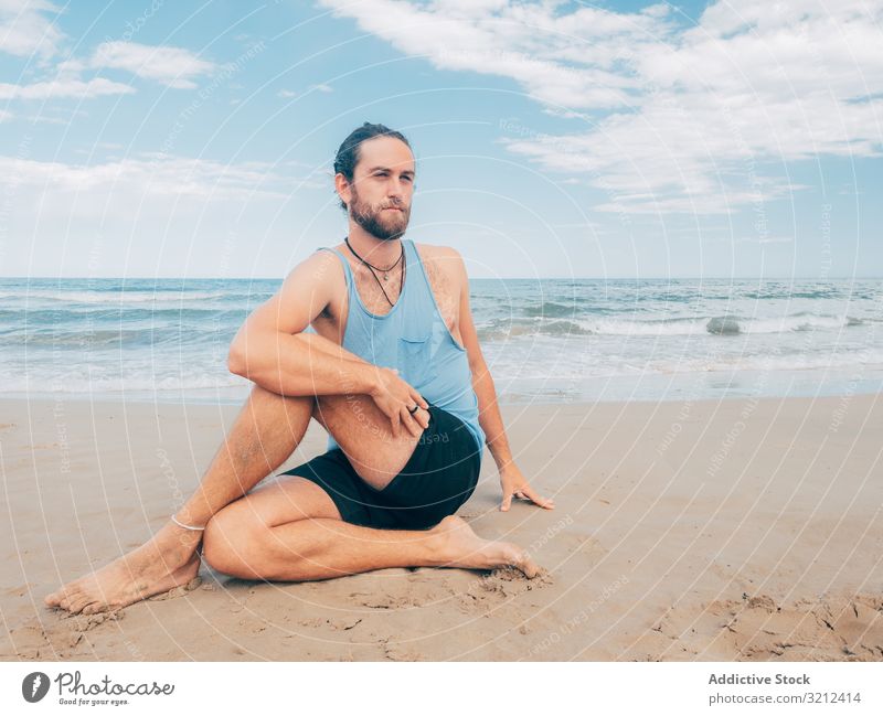 Man training yoga on beach man rest harmony asana exercise seashore energy meditation equilibrium stretch zen relax balance sport lifestyle calm male bearded