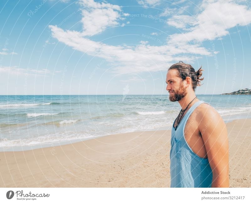 Man standing on the beach man rest calm relaxed resort harmony summer beard hobby vacation active ocean resting male travel happy handsome attractive adult