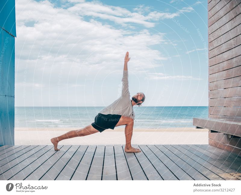 Man doing yoga by the beach man rest calm resort brutal harmony relax summer beard practice hobby asana sport vacation stretching active sitting training ocean