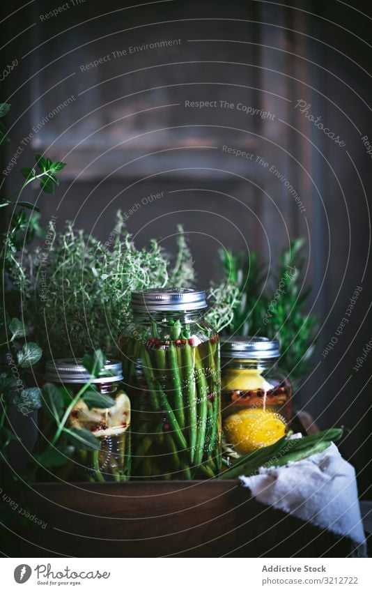 Fresh green vegetables with fruits and glass jars rustic box ingredient organic farm preservation bean plant lemon autumn wholesome harvest potted fresh food