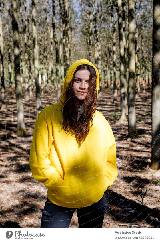 Pretty sportive girl standing in forest sweatshirt walk adventure tourism travel teenager female young person brunette beautiful serious pensive thoughtful