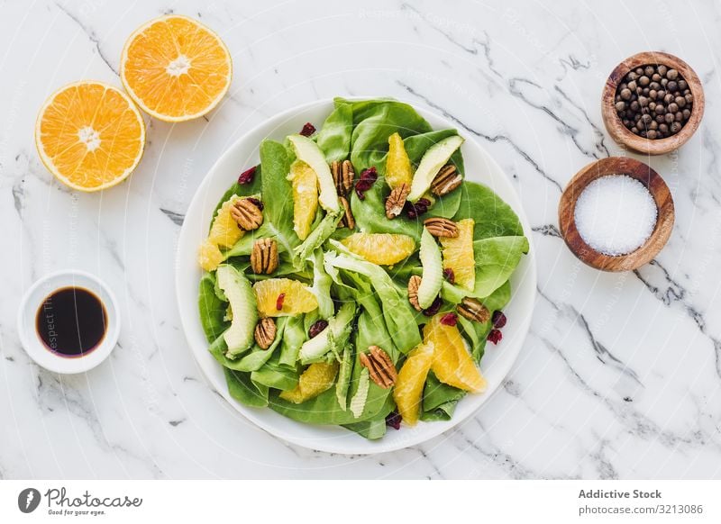 Served avocado and orange with pecan delicious served food meal gourmet cuisine nutrition dinner fruit vegan vegetarian plate bowl tasty diet health nuts dish