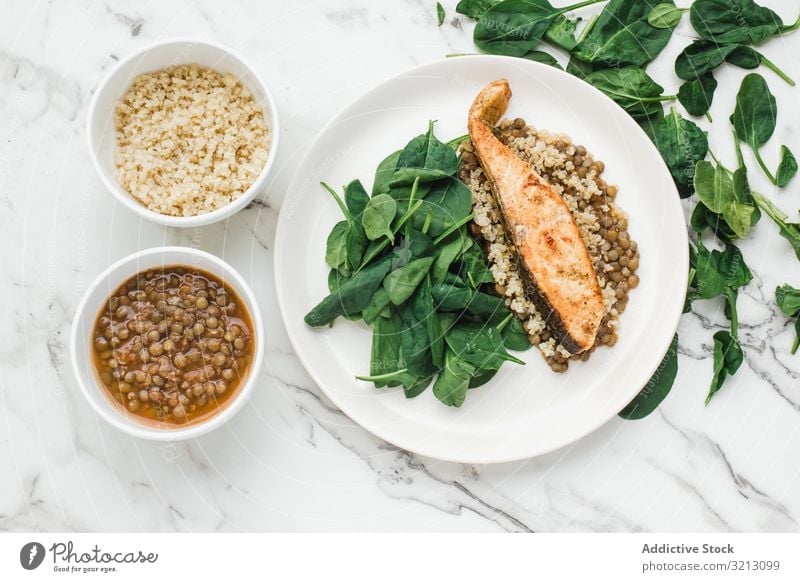 Served salmon steak with beans and couscous spinach greenery tasty delicious served food meal gourmet nutrition dinner spice fish plate bowl diet health dish