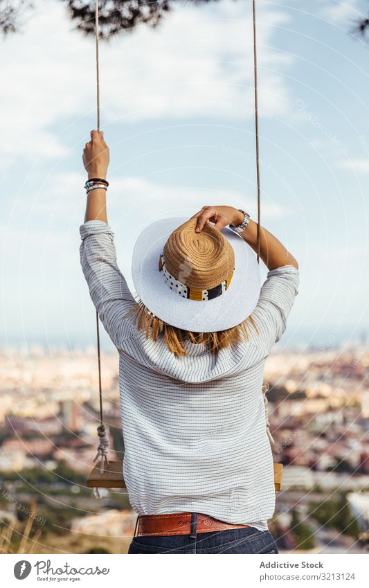 Girl with hat watching the city girl looking travel view swing young lady woman female outdoor tourism barcelona vacation tourist adventure landscape lifestyle