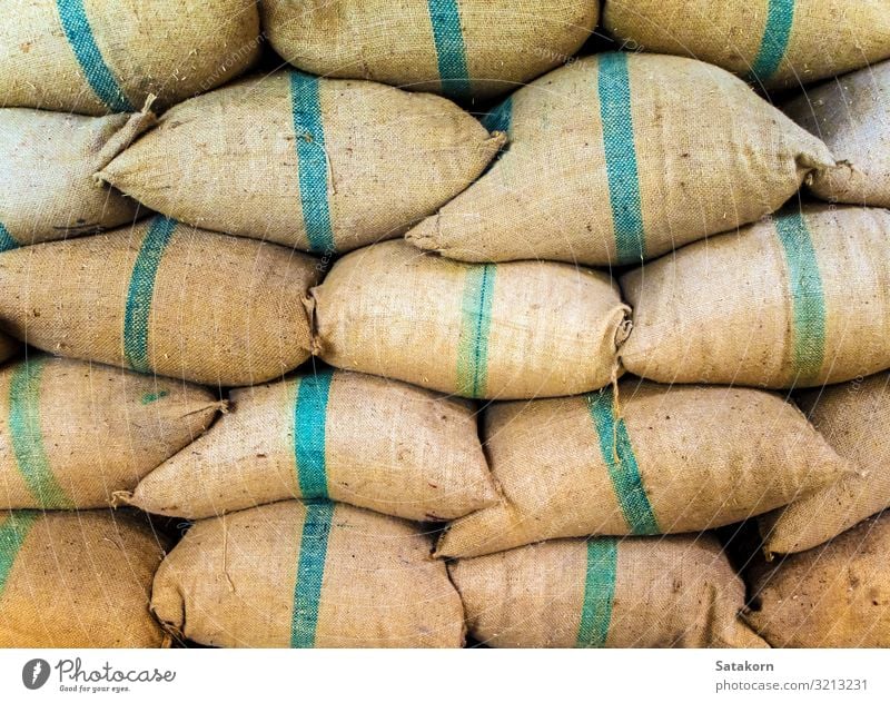 Rice in sacks stacked up a lot Factory Packaging Package Sack Fat Brown Green paddy bulk Storage Stack Warehouse food background wall Consistency agriculture