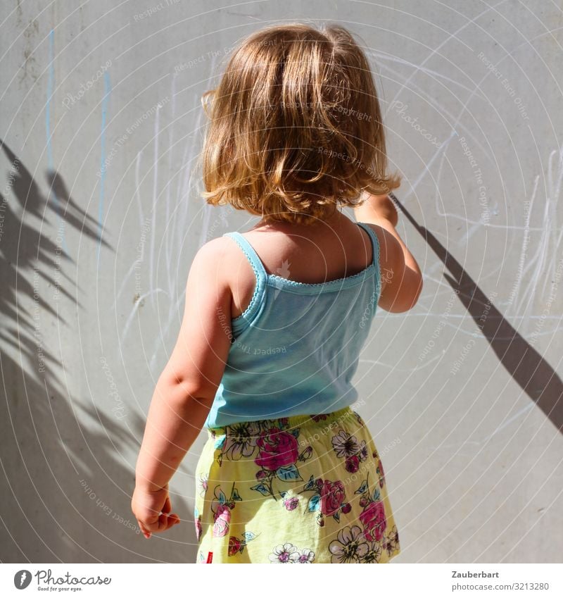 Little girl paints in sunlight on grey wall Feminine Child Girl Infancy 1 Human being 3 - 8 years T-shirt Skirt Blonde Discover Draw Playing Happy Small Cute